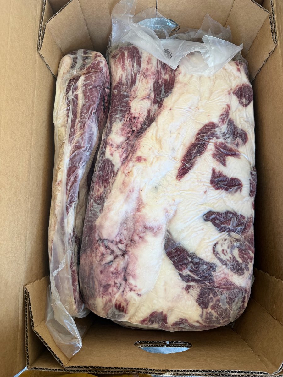 Frozen boneless beef short plate, vacuum-packed in an export carton, marbled side up